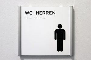 WC-Schild mit Piktogramm und taktiler Beschriftung